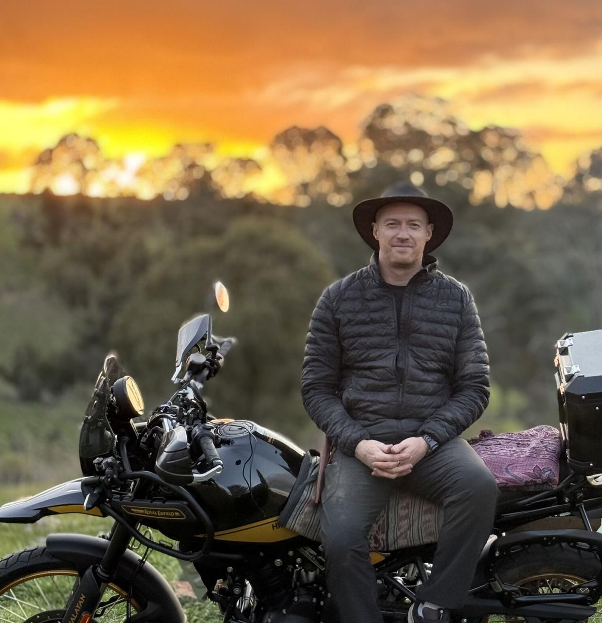 Robin Leonard on Royal Enfield Himalayan during solo expedition at sunset